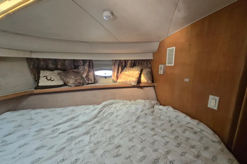 Slide: The Image of Cozy cabin interior of 1995 Carver 430 Cockpit Motor Yacht with bed and window. - 14