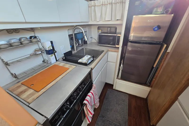 Slide: The Image of Compact kitchen in a 1995 Carver 430 Cockpit Motor Yacht with modern appliances. - 19