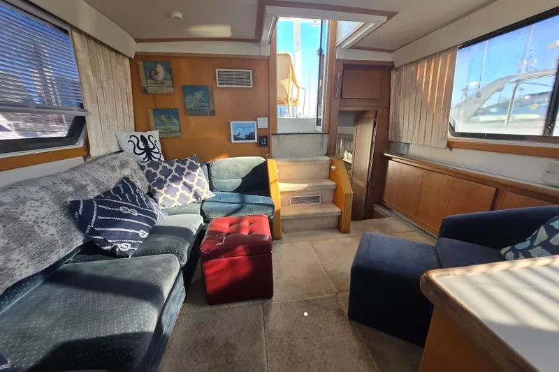 Slide: The Image of Interior of 1995 Carver 430 Cockpit Motor Yacht with cozy seating and nautical decor. - 2