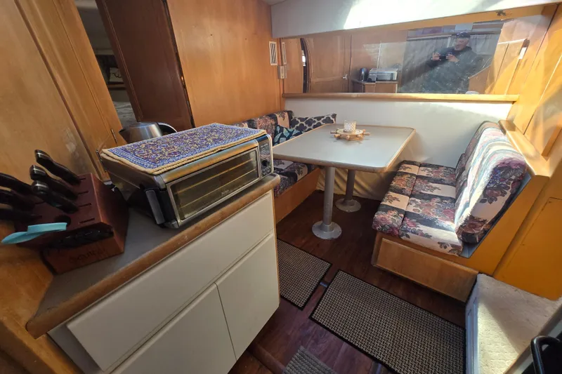 Slide: The Image of Interior of 1995 Carver 430 Cockpit Motor Yacht with dining area and kitchenette. - 20