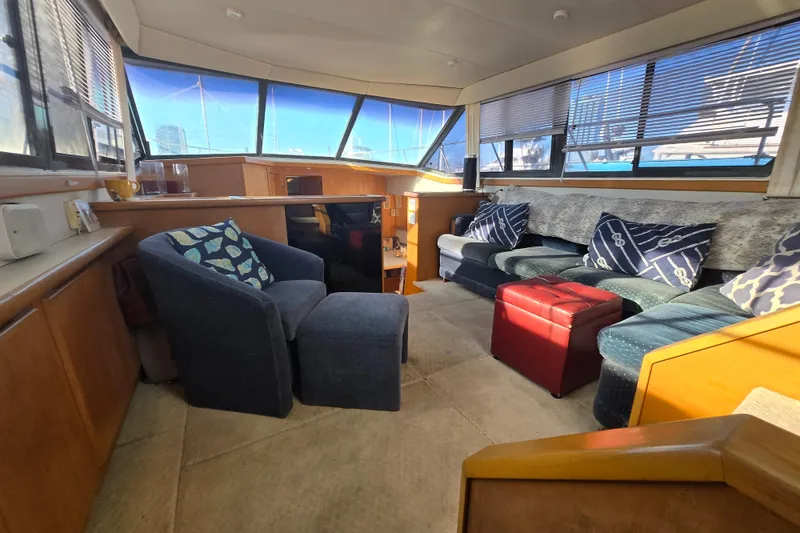Slide: The Image of Interior of 1995 Carver 430 Cockpit Motor Yacht with cozy seating and panoramic windows. - 23