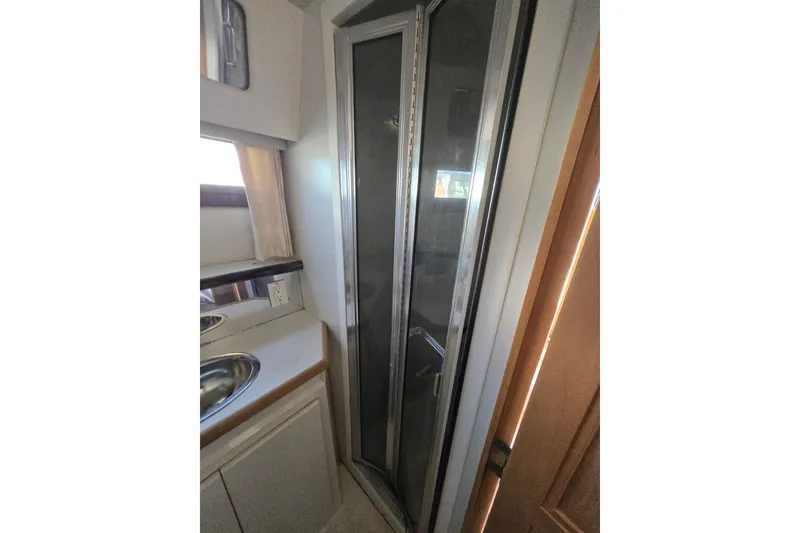 Slide: The Image of Interior of 1995 Carver 430 Cockpit Motor Yacht showing bathroom with shower and sink. - 27