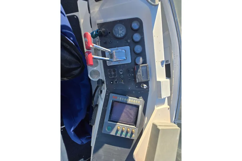 Slide: The Image of 1995 Carver 430 Cockpit Motor Yacht helm with controls and navigation instruments. - 33