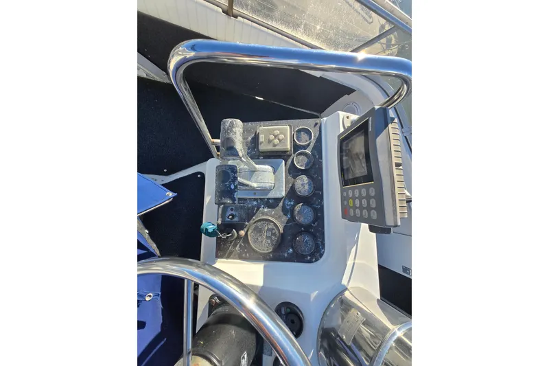 Slide: The Image of 1995 Carver 430 Cockpit Motor Yacht helm with navigation controls and display screen. - 34