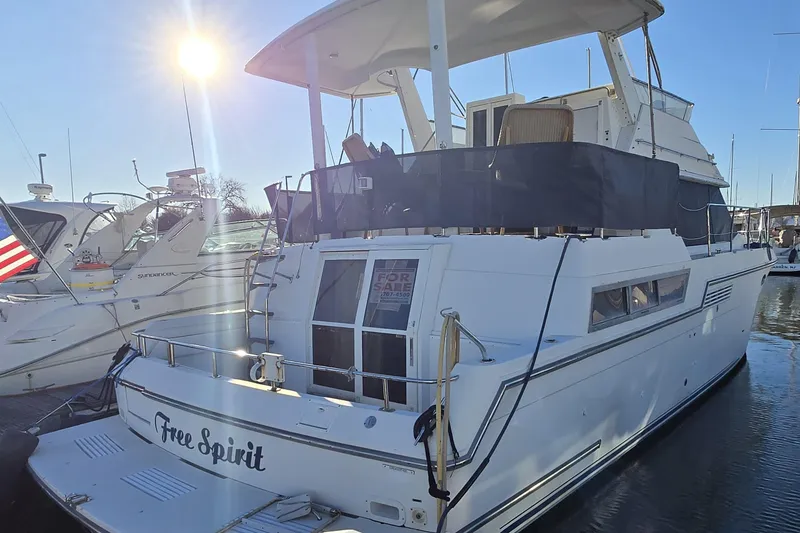 Slide: The Image of 1995 Carver 430 Cockpit Motor Yacht "Free Spirit" docked, for sale under sunny sky. - 42