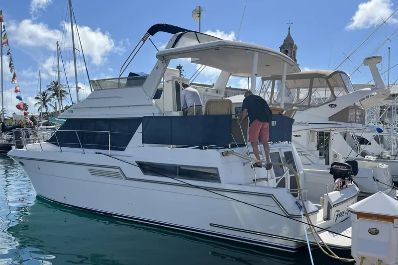 Slide: The Image of 1999 Carver 430 Cockpit Motor Yacht docked in a sunny marina. - 44