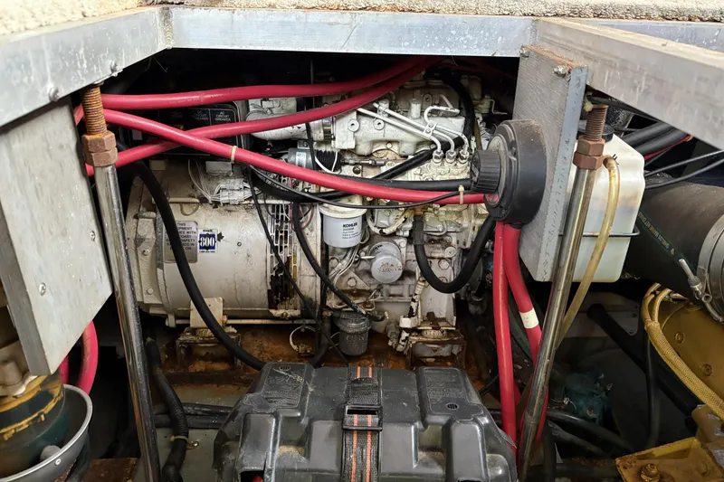 Slide: The Image of Engine compartment of a 1999 Carver 430 Cockpit Motor Yacht with visible wiring and components. - 49