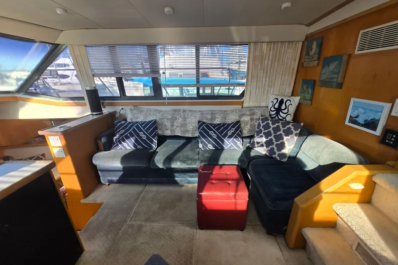 Slide: The Image of Interior of 1995 Carver 430 Cockpit Motor Yacht with cozy seating and nautical decor. - 8