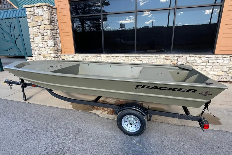 The Image of 2026 Tracker Grizzly 1648 Utility boat on trailer, parked outdoors. - 0