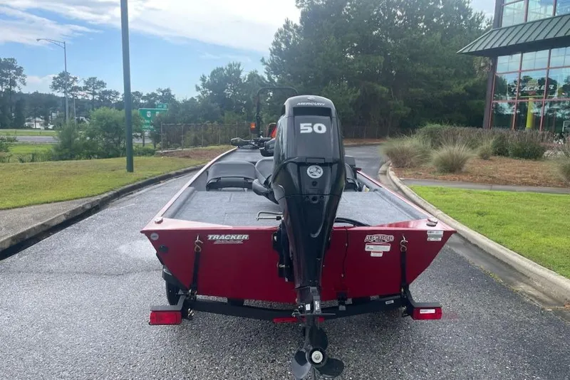 Slide: The Image of 2026 Tracker Bass Tracker Classic XL boat with Mercury 50 engine, parked outdoors. - 2