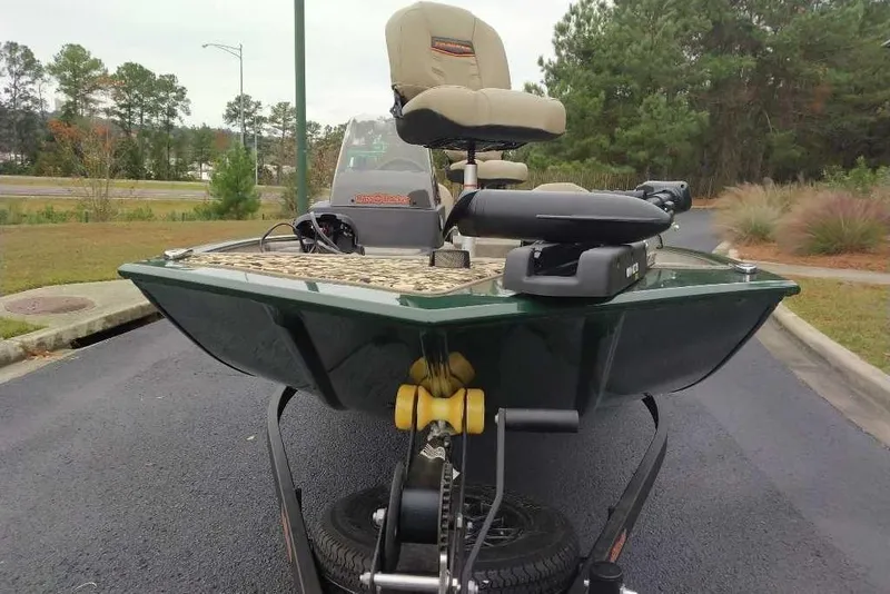 Slide: The Image of 2026 Tracker Bass Tracker Classic Limited boat on trailer, parked on asphalt near greenery. - 4