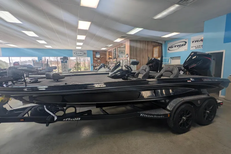 The Image of 2026 Triton 20XP Patriot boat displayed in showroom with modern design and features. - 0