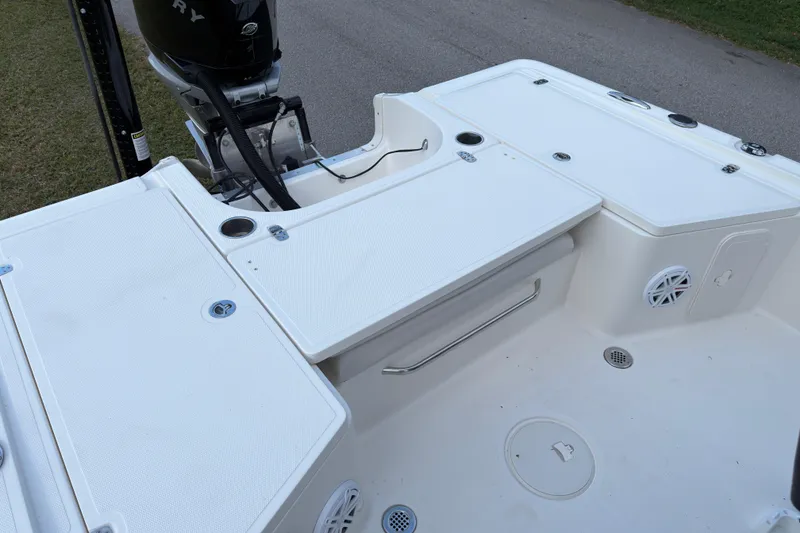 Slide: The Image of 2019 Wellcraft 241 Bay boat deck with storage compartments and Mercury outboard motor. - 14