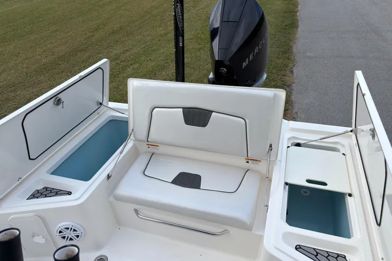 Slide: The Image of 2019 Wellcraft 241 Bay boat interior with storage compartments and Mercury engine. - 15