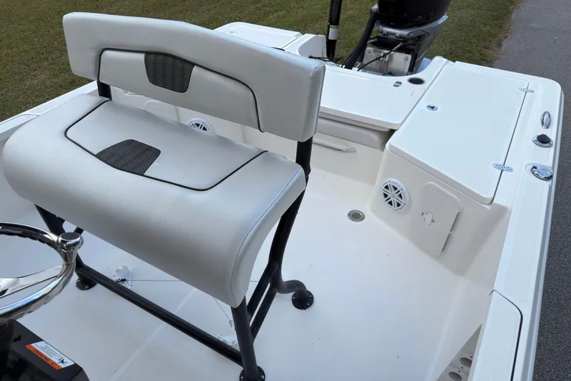 Slide: The Image of 2019 Wellcraft 241 Bay boat interior with seating and steering wheel. - 16