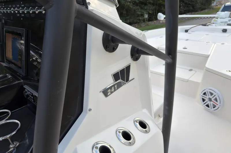 Slide: The Image of 2019 Wellcraft 241 Bay boat interior with control panel and logo detail. - 21