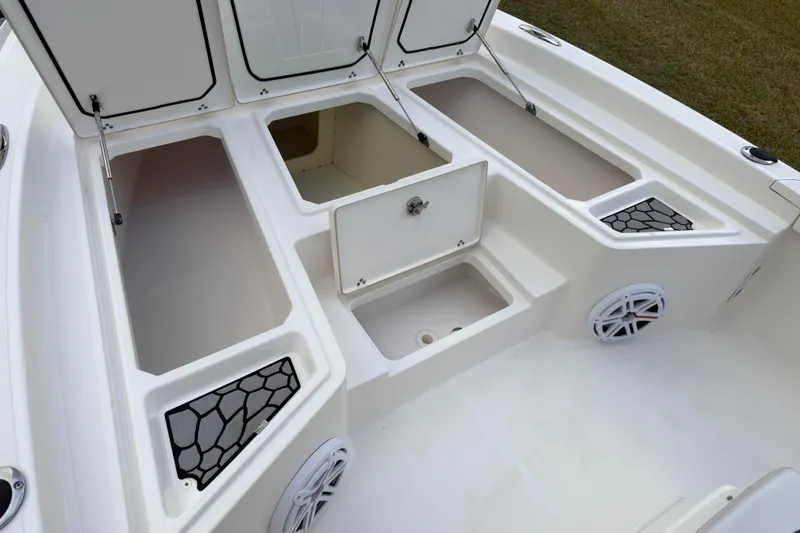 Slide: The Image of 2019 Wellcraft 241 Bay boat storage compartments and speakers, showcasing ample space and functionality. - 23