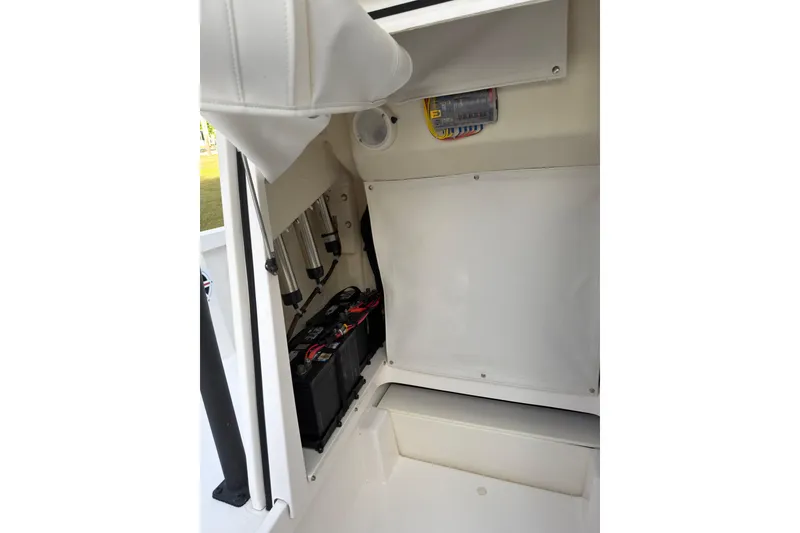 Slide: The Image of 2019 Wellcraft 241 Bay boat interior showing battery compartment and wiring. - 28