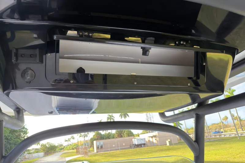 Slide: The Image of 2019 Wellcraft 241 Bay boat console with storage compartment and scenic background. - 30