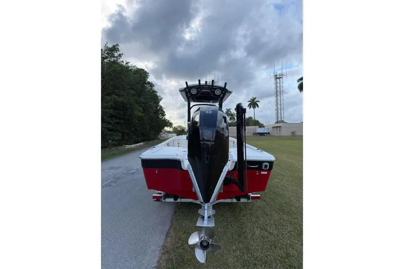 Slide: The Image of 2019 Wellcraft 241 Bay boat with outboard motor on a grassy roadside. - 4