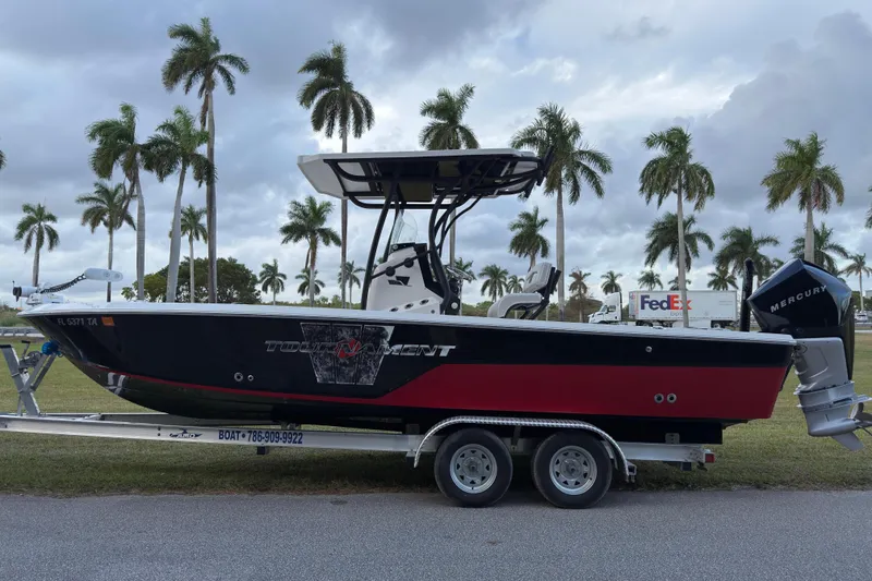 Slide: The Image of 2019 Wellcraft 241 Bay boat on trailer, palm trees in background. - 6