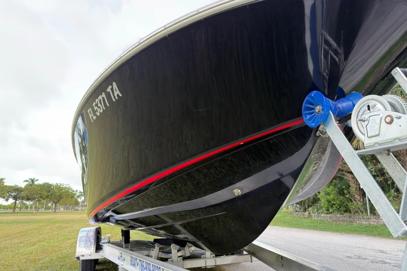 Slide: The Image of 2019 Wellcraft 241 Bay boat on trailer, close-up view of hull and winch. - 9