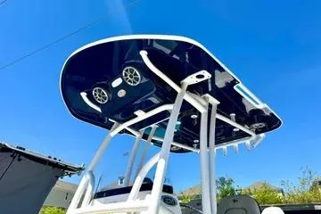 Slide: The Image of 2022 Seapro 228 Bay boat with T-top and speakers under clear blue sky. - 17