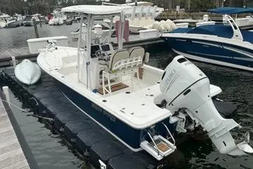 Slide: The Image of 2022 Seapro 228 Bay boat docked at marina with outboard motor. - 19