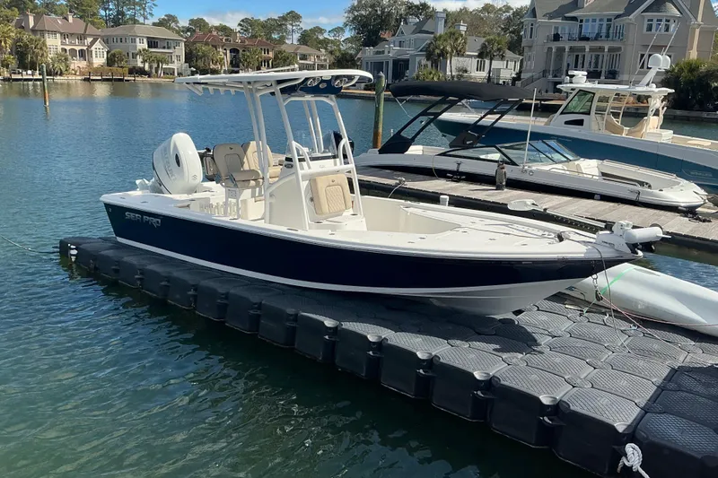Slide: The Image of 2022 Seapro 228 Bay boat docked on a serene waterfront. - 20