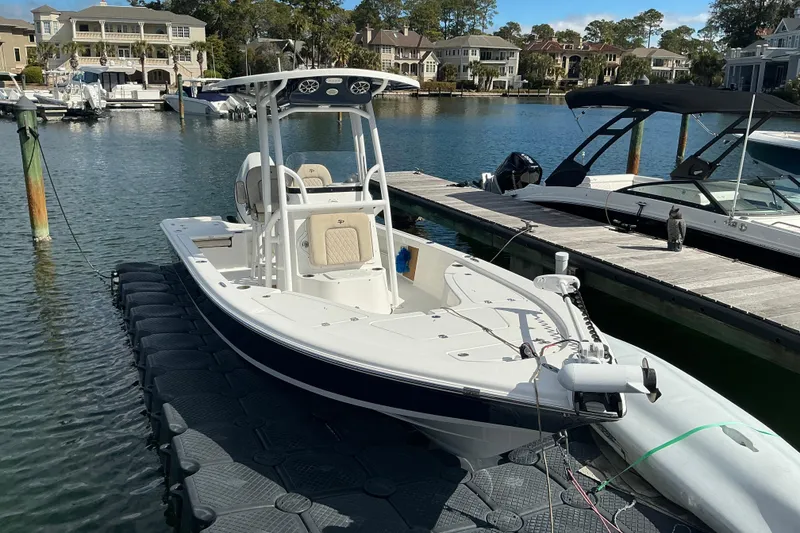 Slide: The Image of 2022 Seapro 228 Bay boat docked in a scenic marina setting. - 21