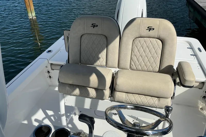 Slide: The Image of 2022 Seapro 228 Bay boat interior with beige seats and steering wheel. - 24
