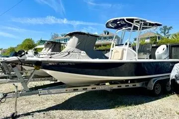 Slide: The Image of 2022 Seapro 228 Bay boat on trailer, parked outdoors under clear blue sky. - 3