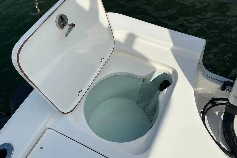 Slide: The Image of 2022 Seapro 228 Bay boat livewell with open lid, showcasing interior design. - 32
