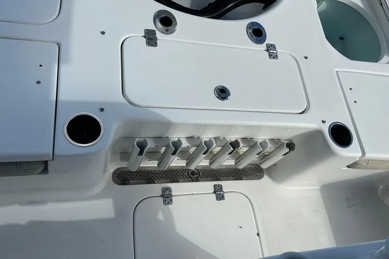 Slide: The Image of 2022 Seapro 228 Bay boat deck with rod holders and storage compartments. - 37