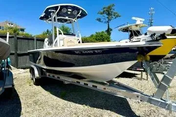 Slide: The Image of 2022 Seapro 228 Bay boat on trailer, parked outdoors under clear blue sky. - 4