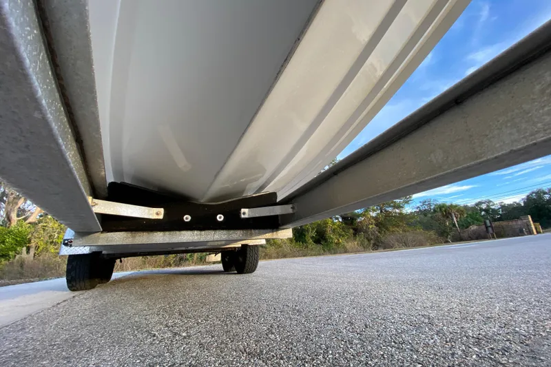 Slide: The Image of Underneath view of a 2020 Pathfinder 2500 Hybrid boat on a trailer. - 14