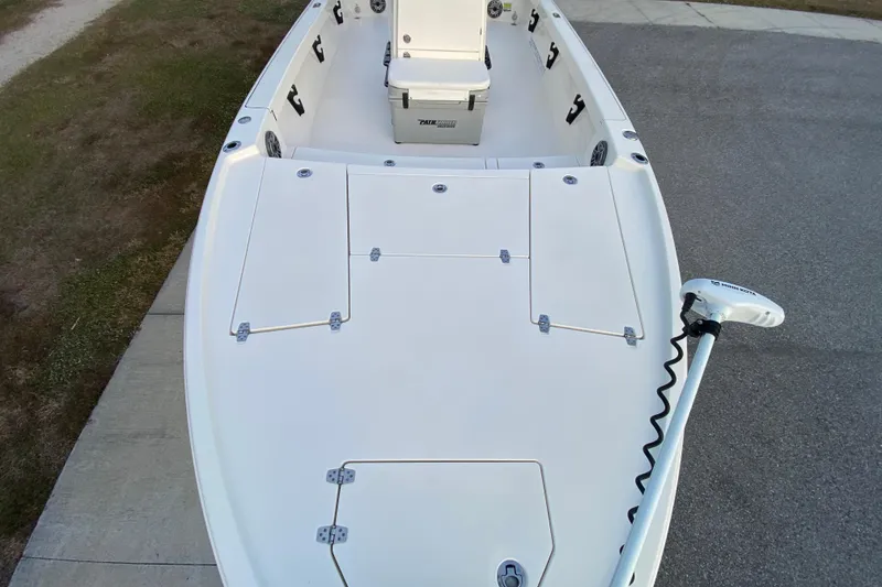 Slide: The Image of 2020 Pathfinder 2500 Hybrid boat deck with storage compartments and trolling motor. - 17