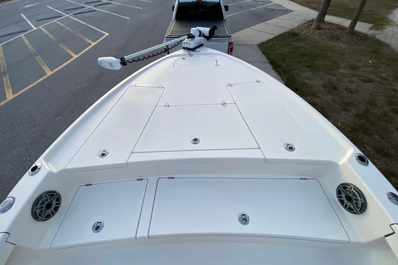 Slide: The Image of 2020 Pathfinder 2500 Hybrid boat deck with storage compartments and trolling motor. - 18