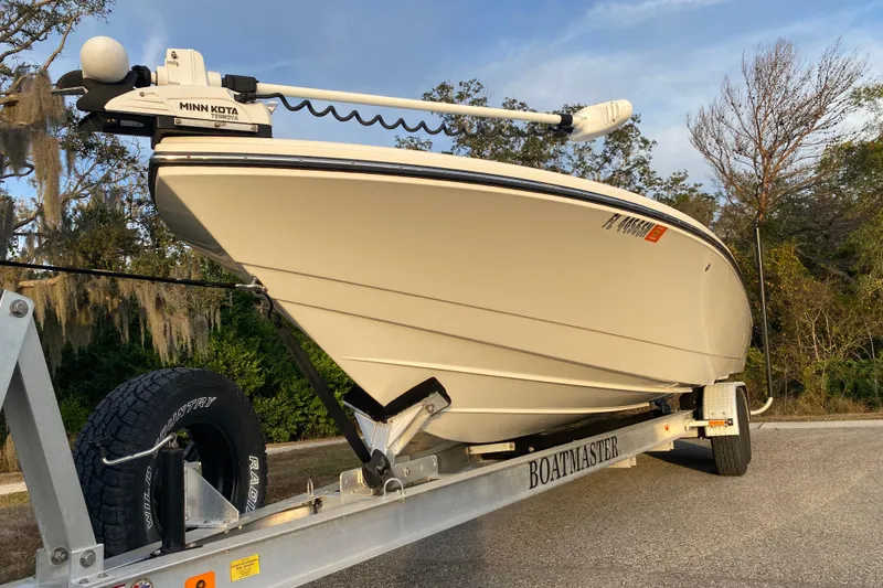 Slide: The Image of 2020 Pathfinder 2500 Hybrid boat on trailer with Minn Kota motor, parked outdoors. - 2