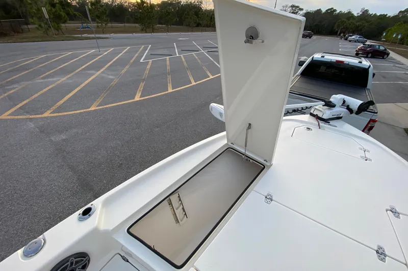 Slide: The Image of 2020 Pathfinder 2500 Hybrid boat with open storage compartment in a parking lot. - 23