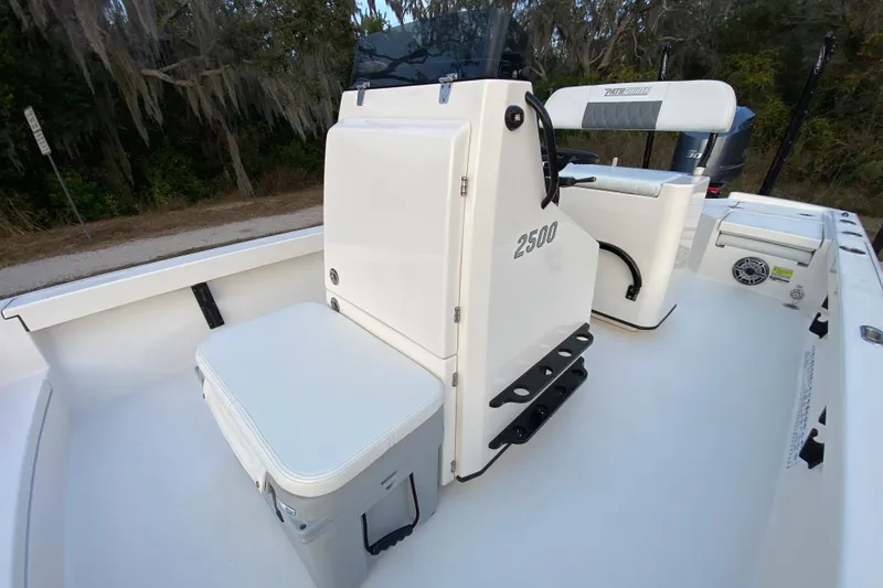 Slide: The Image of 2020 Pathfinder 2500 Hybrid boat interior with seating and console, set in a natural environment. - 36