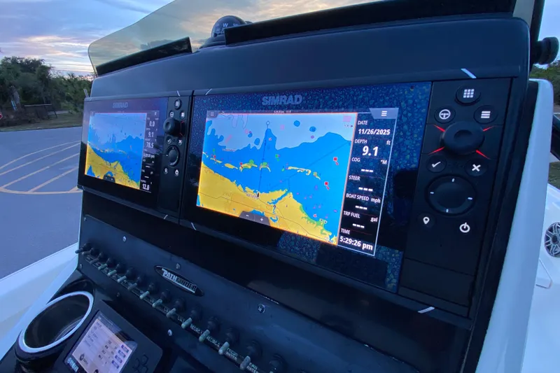 Slide: The Image of Simrad navigation system on 2020 Pathfinder 2500 Hybrid boat dashboard at sunset. - 43