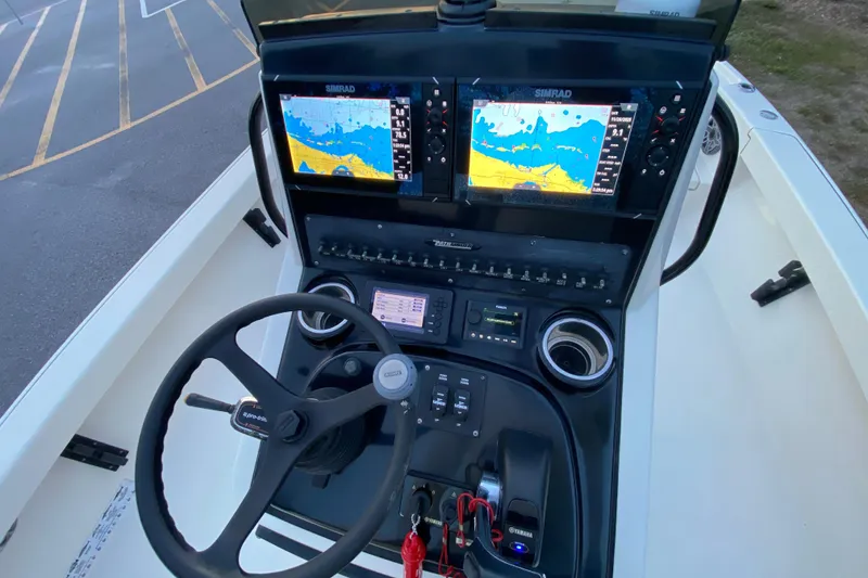 Slide: The Image of Pathfinder 2500 Hybrid 2020 boat dashboard with dual Simrad displays and steering wheel. - 44