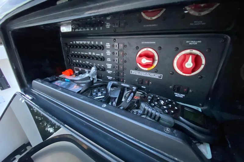 Slide: The Image of Control panel of a 2020 Pathfinder 2500 Hybrid boat with switches and dials. - 47