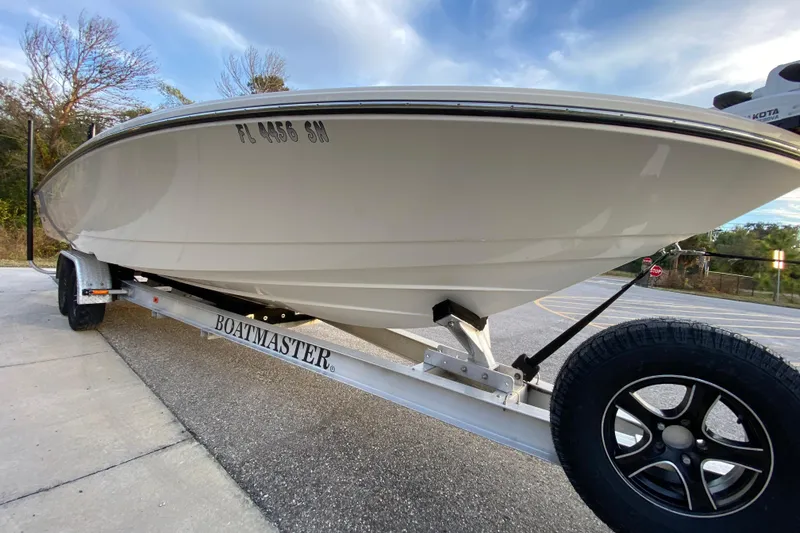 Slide: The Image of 2020 Pathfinder 2500 Hybrid boat on Boatmaster trailer, parked on pavement. - 5