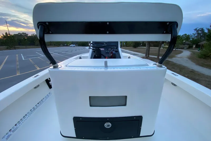 Slide: The Image of 2020 Pathfinder 2500 Hybrid boat interior with console and seating, parked at sunset. - 52