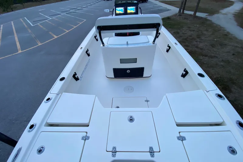 Slide: The Image of 2020 Pathfinder 2500 Hybrid boat interior with storage compartments and seating in a parking lot. - 57