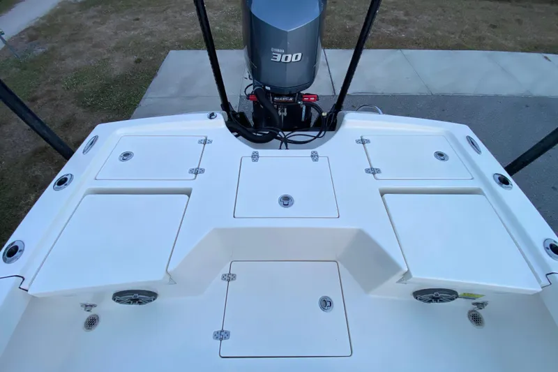 Slide: The Image of 2020 Pathfinder 2500 Hybrid boat deck with Yamaha 300 engine, storage compartments, and speakers. - 58
