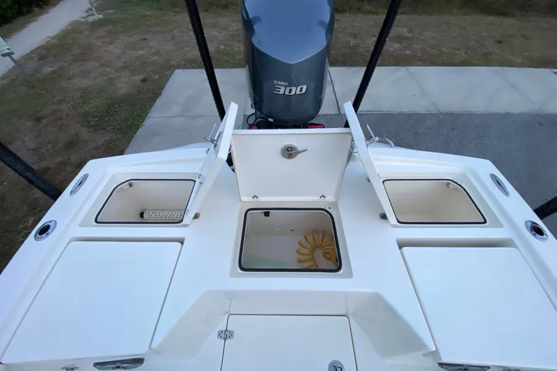 Slide: The Image of 2020 Pathfinder 2500 Hybrid boat deck with open storage compartments and Yamaha 300 engine. - 59