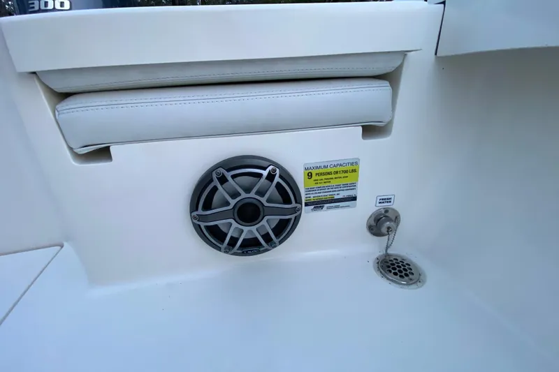 Slide: The Image of 2020 Pathfinder 2500 Hybrid boat interior with speaker, seating, and capacity label. - 61